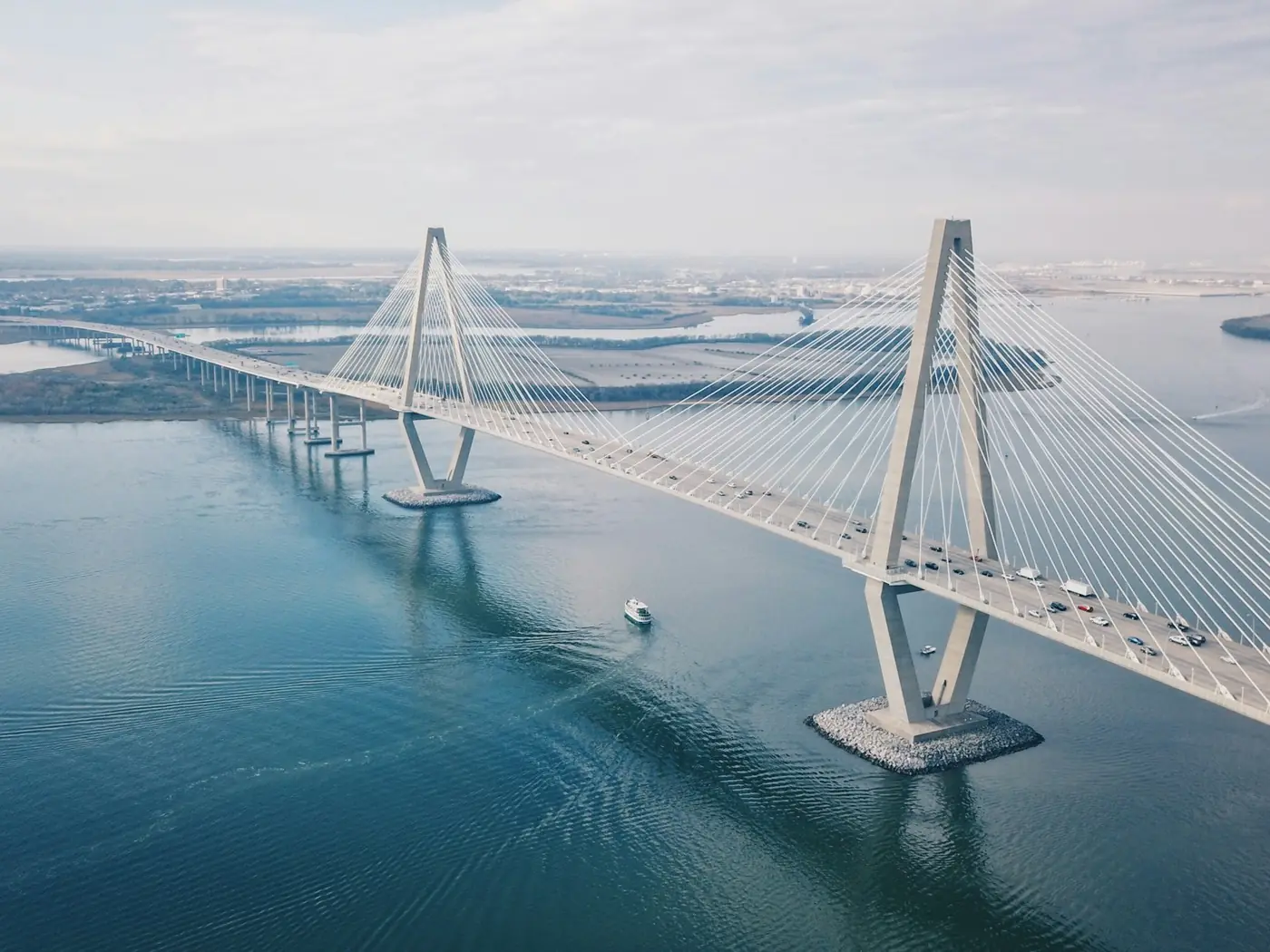 Aerial view along a cable-stayed bridge crossing open water