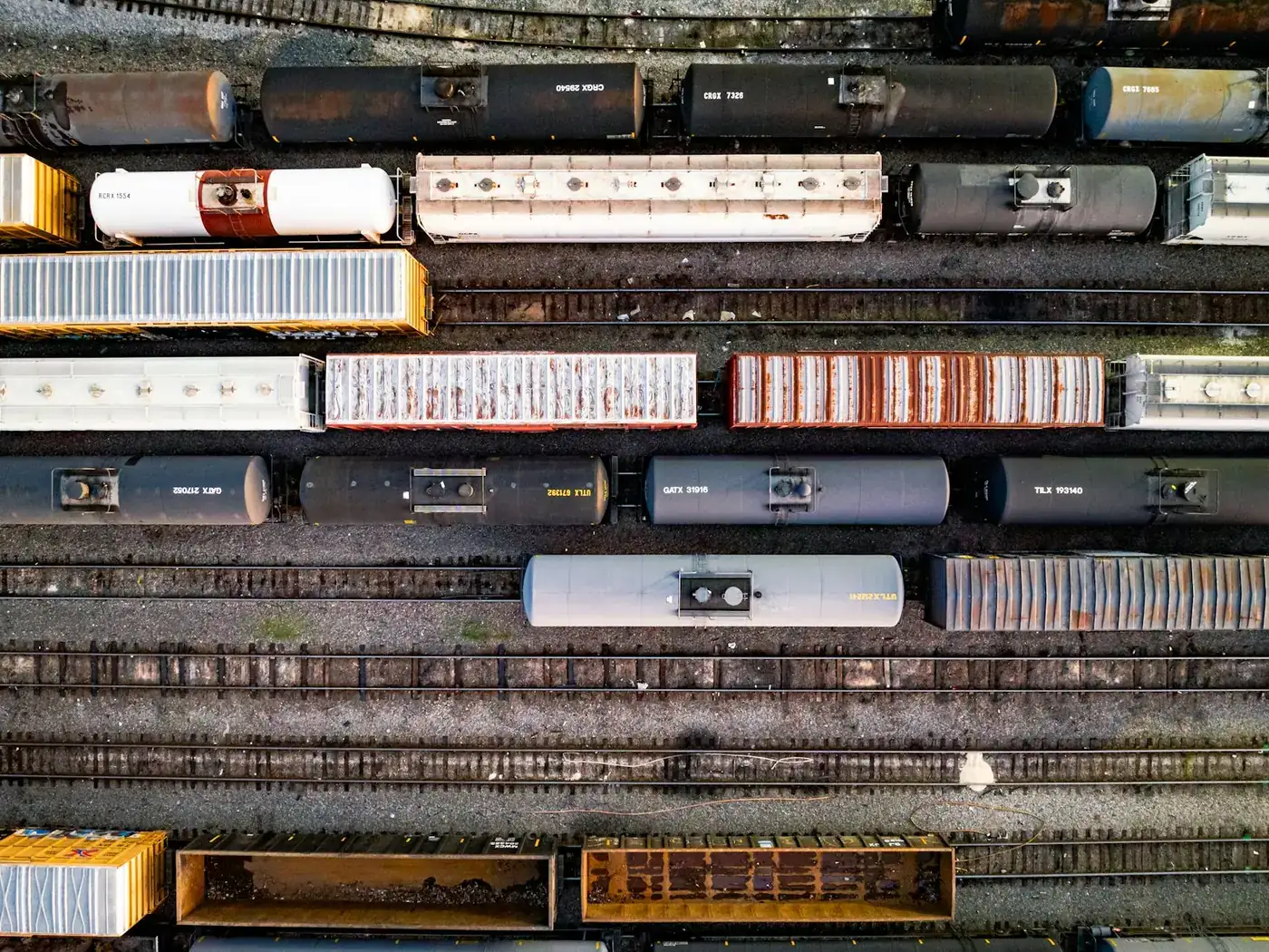 Overhead view of a rail yard with tank wagons on parallel tracks