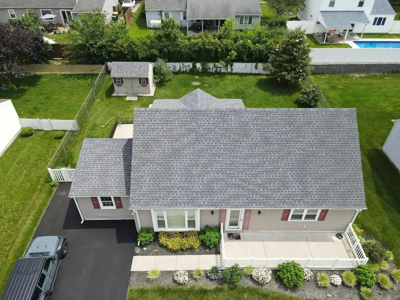 Aerial view of a suburban house with a grey shingle roof