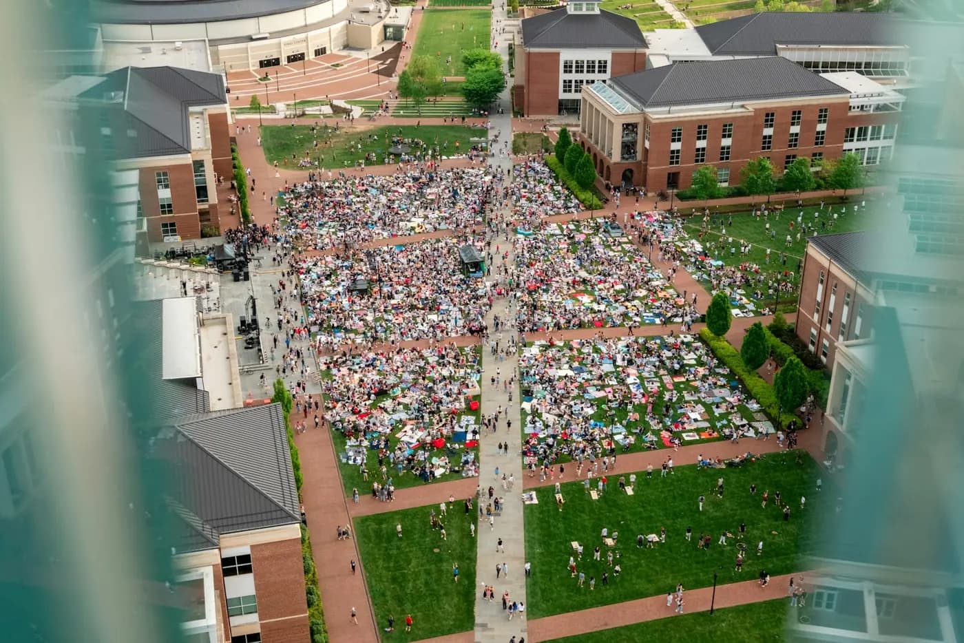 Aerial view of a large crowd gathered on a campus lawn
