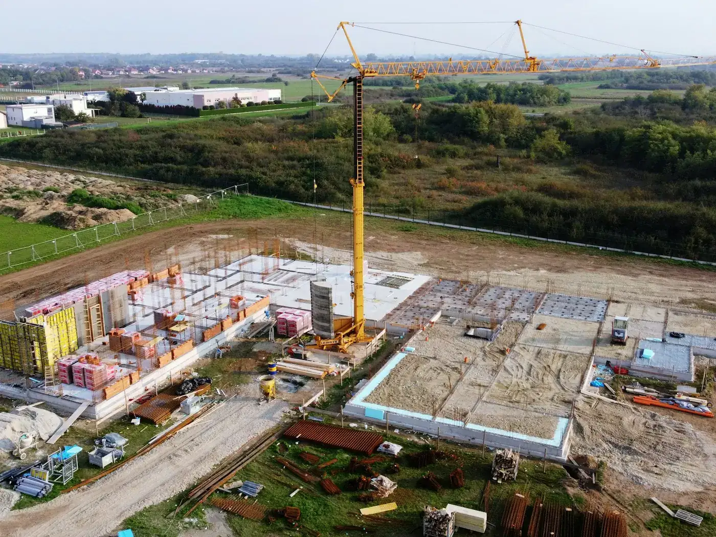 Aerial view of a building under construction with a tower crane