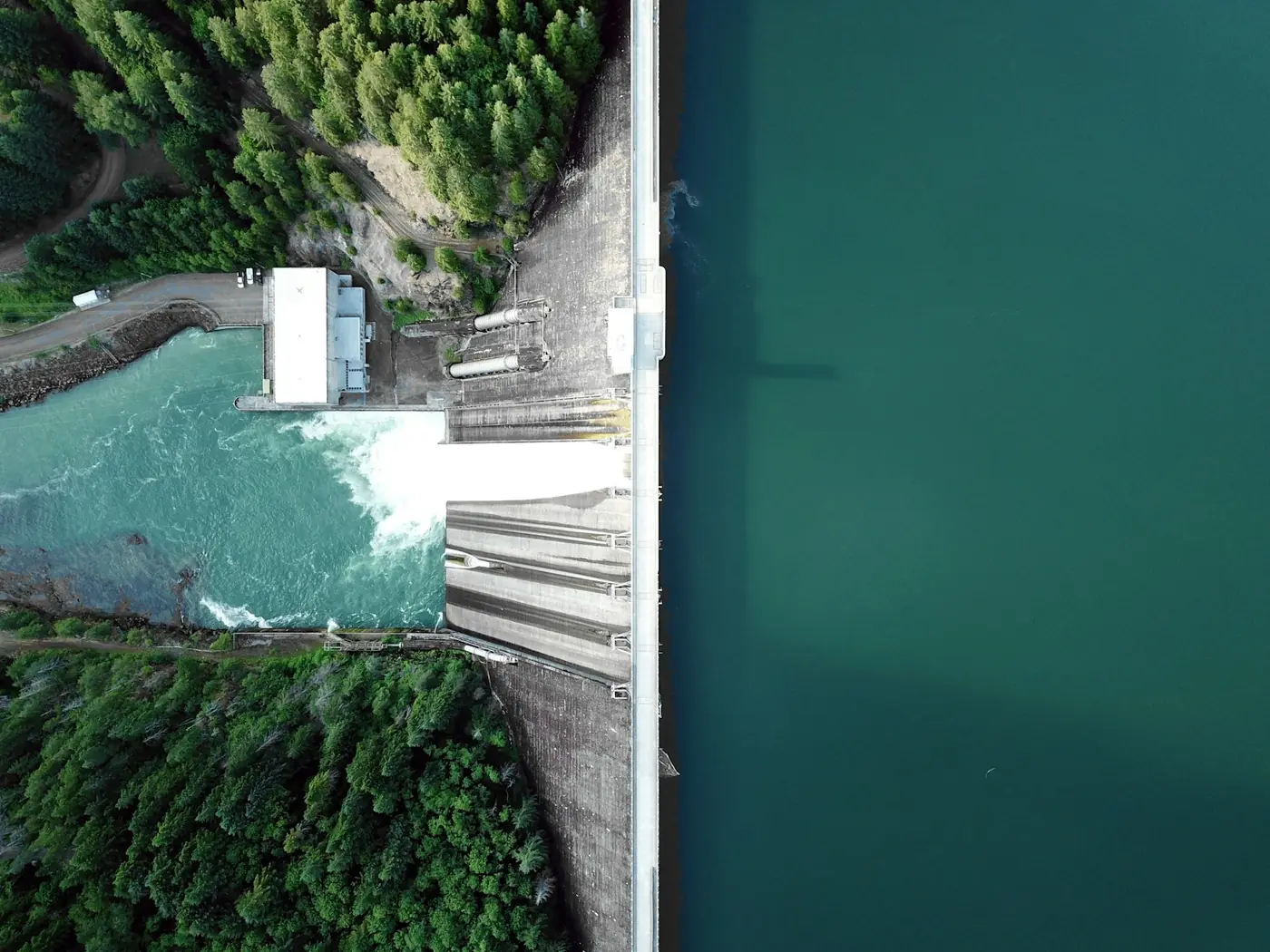 Overhead view of a concrete dam and its spillway