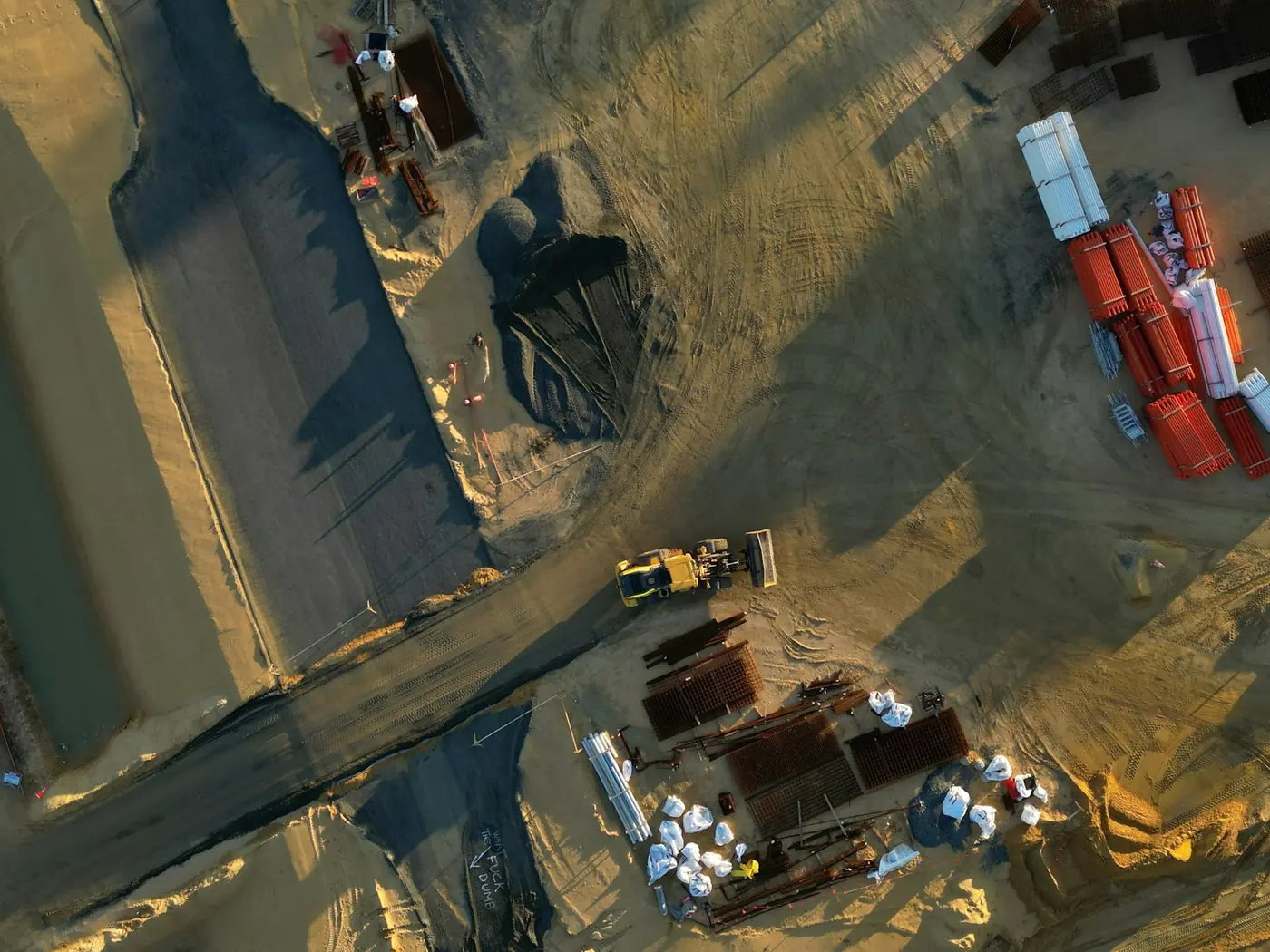 Overhead view of graded earthworks with plant and haul roads