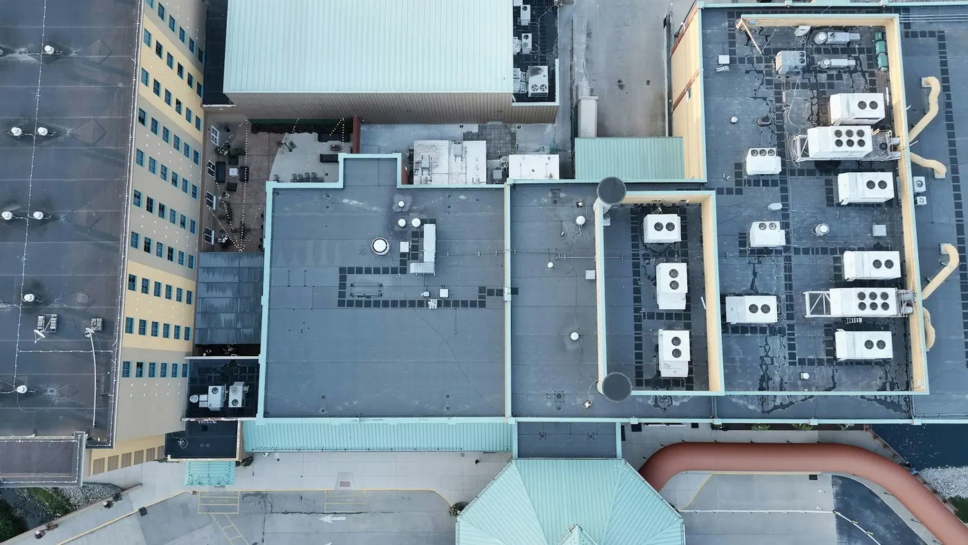 Overhead view of flat roofs crowded with HVAC units