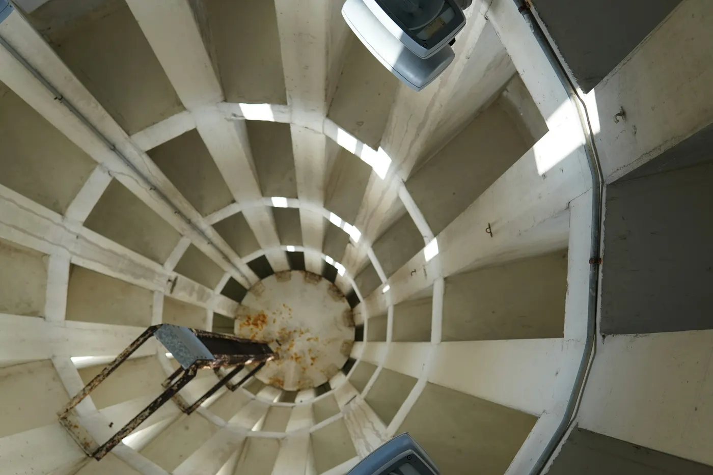 Looking down a spiral of steps inside a round shaft