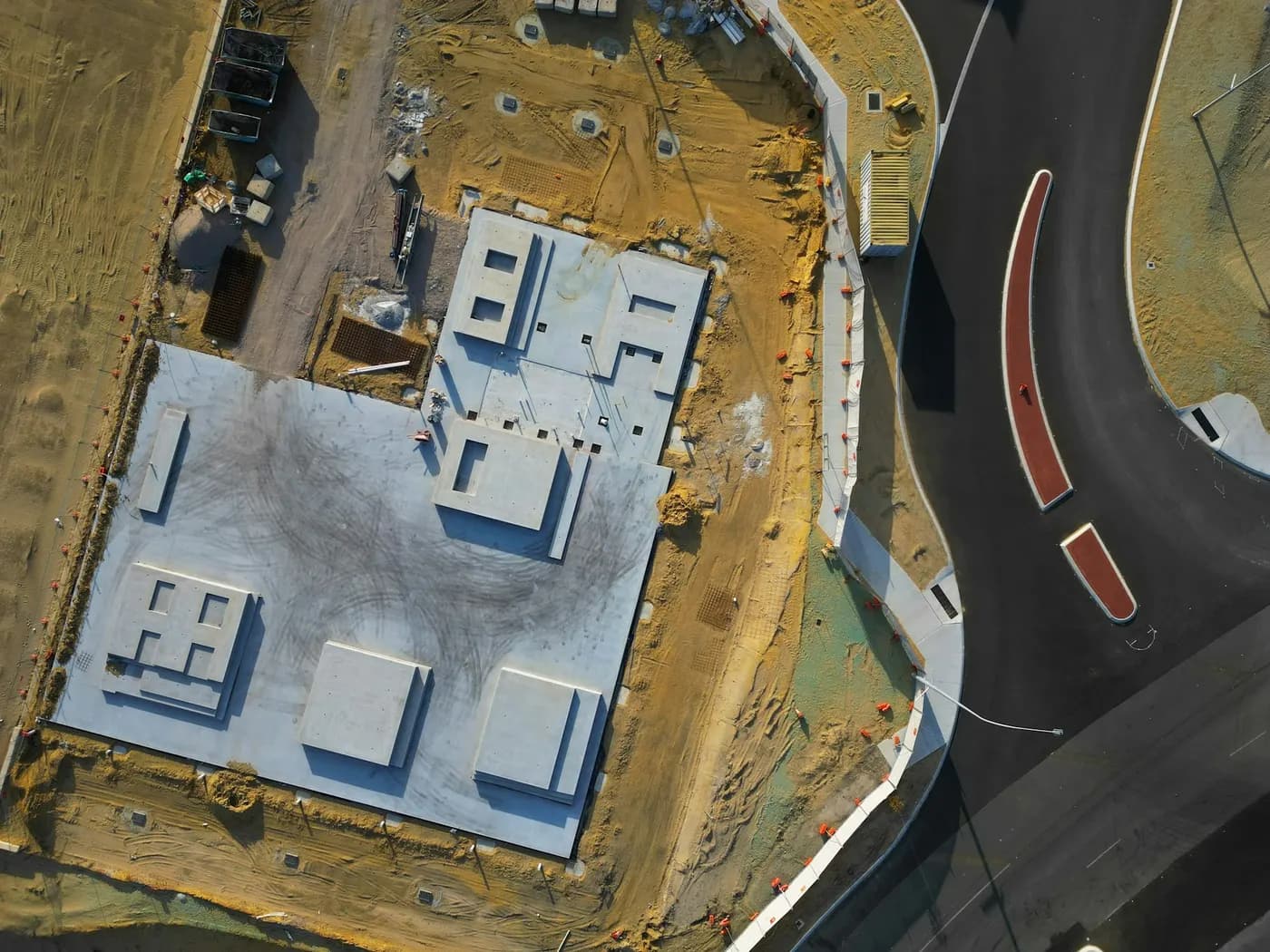 Overhead view of a new building's roof and plant beside a road