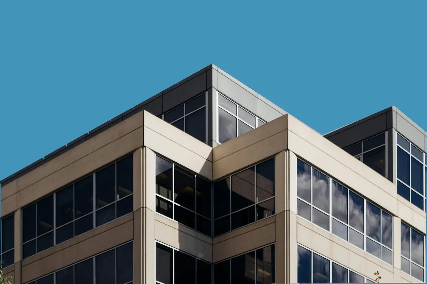 Corner of an office building with glass and stone cladding