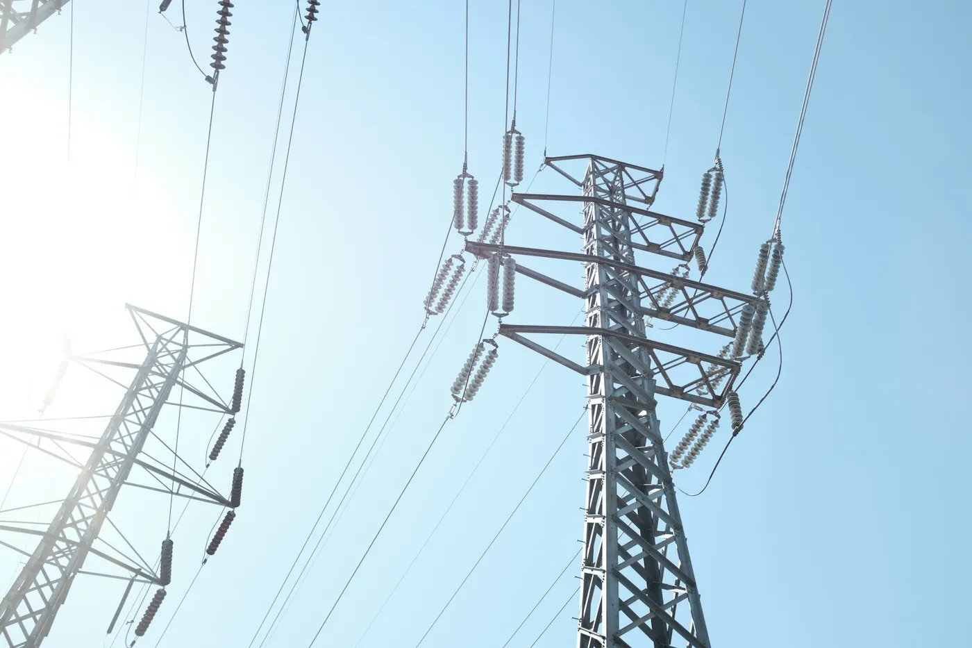 Transmission tower with insulator strings, seen from below