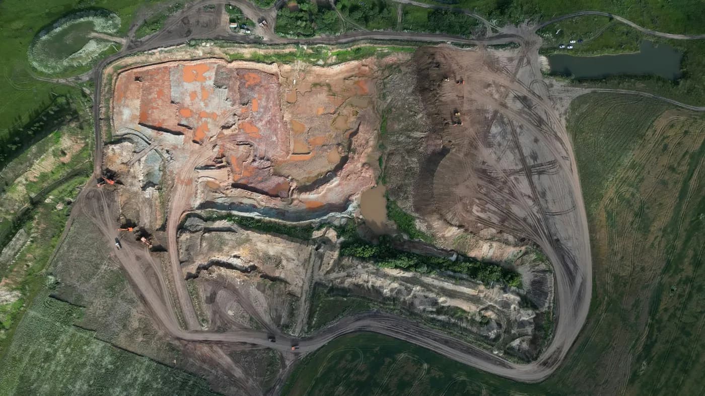 Aerial view of an open-pit quarry with terraced benches