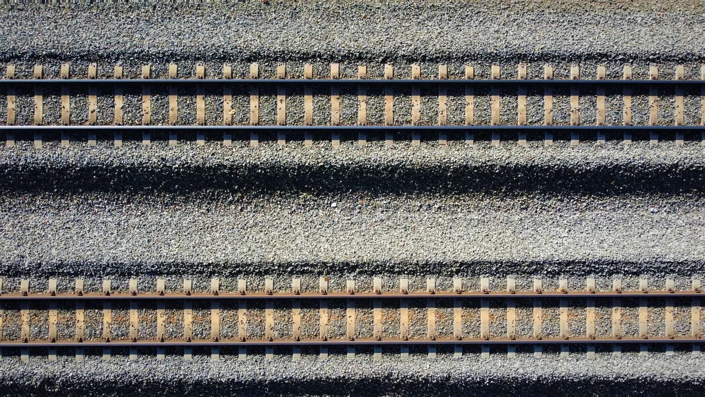 Overhead view of parallel railway tracks and ballast
