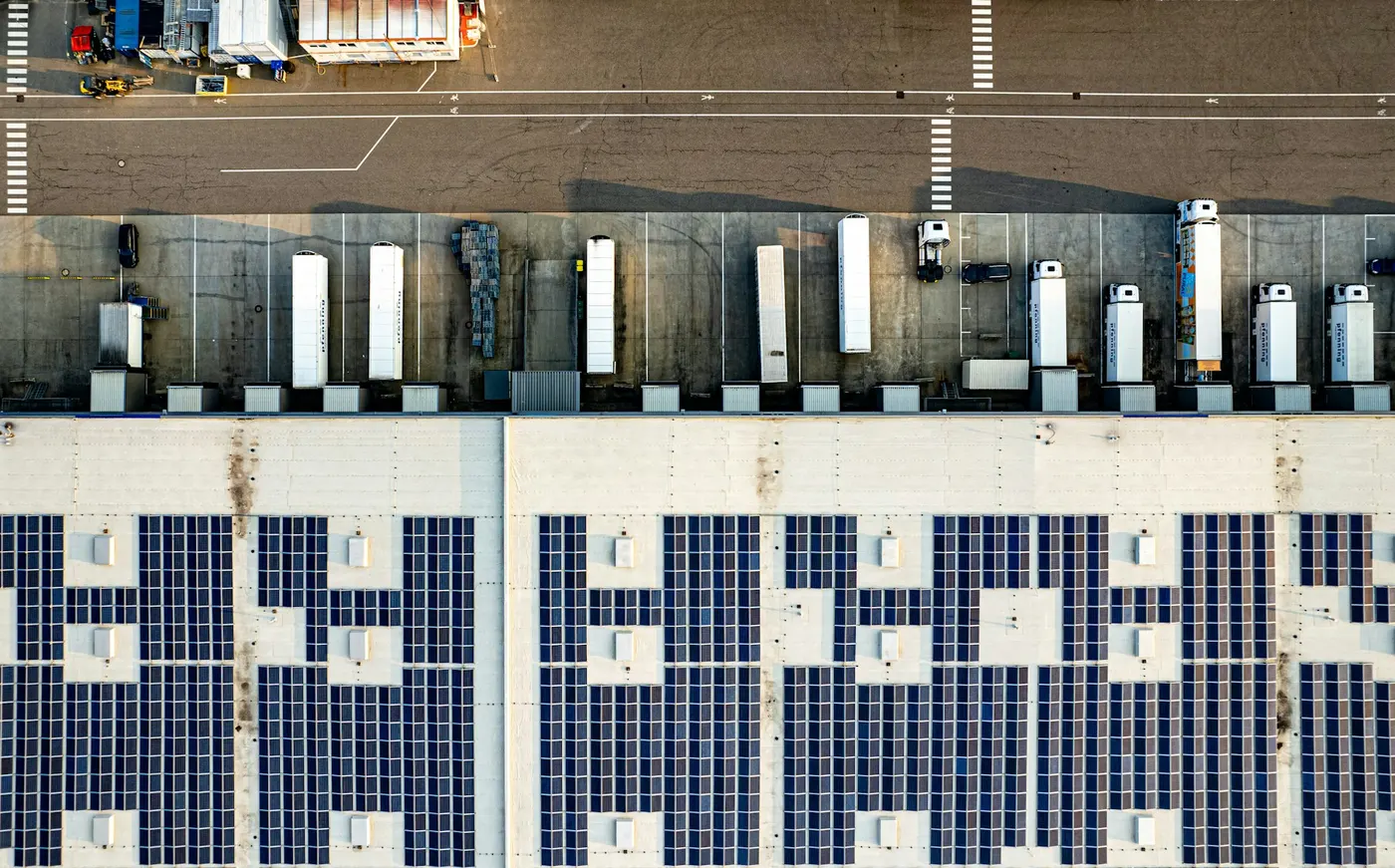 Overhead view of a warehouse roof covered in solar panels