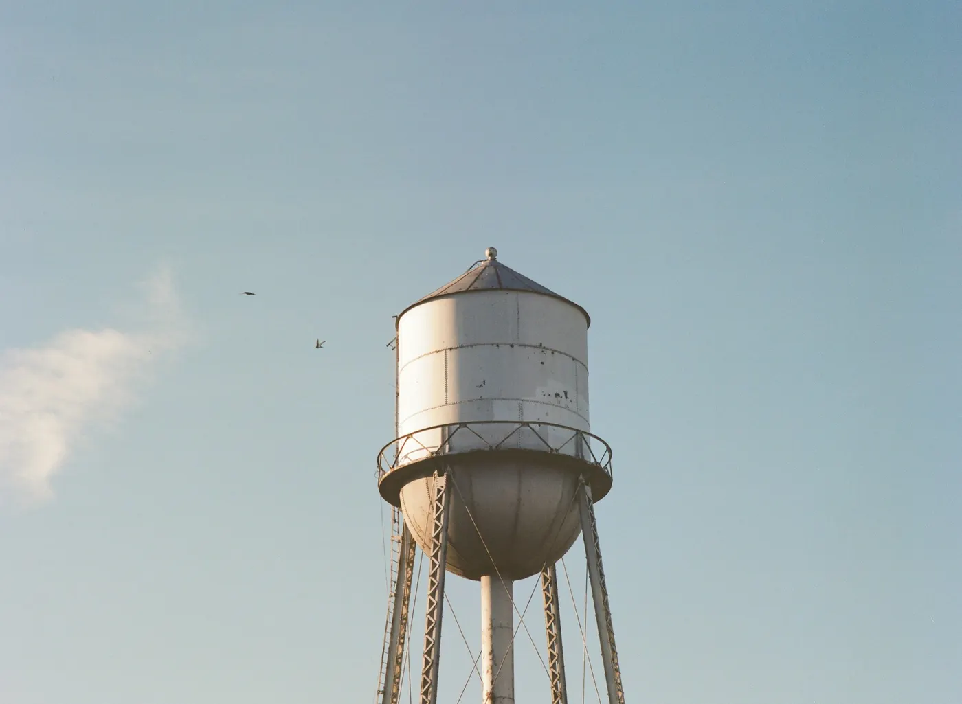 White water tower against a pale sky