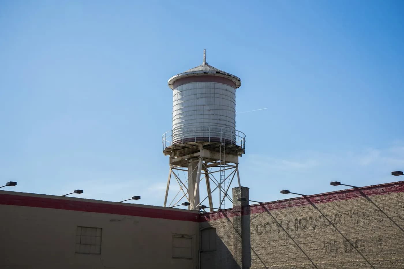 Water tower above a brick industrial building