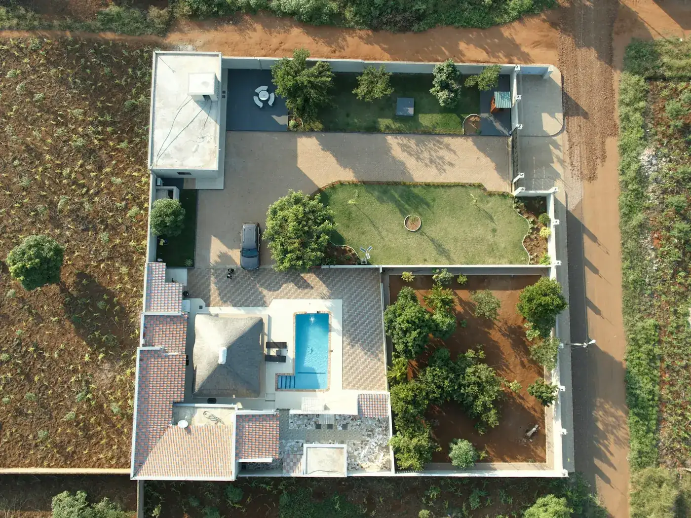 Overhead view of a modern house with a swimming pool and landscaped garden