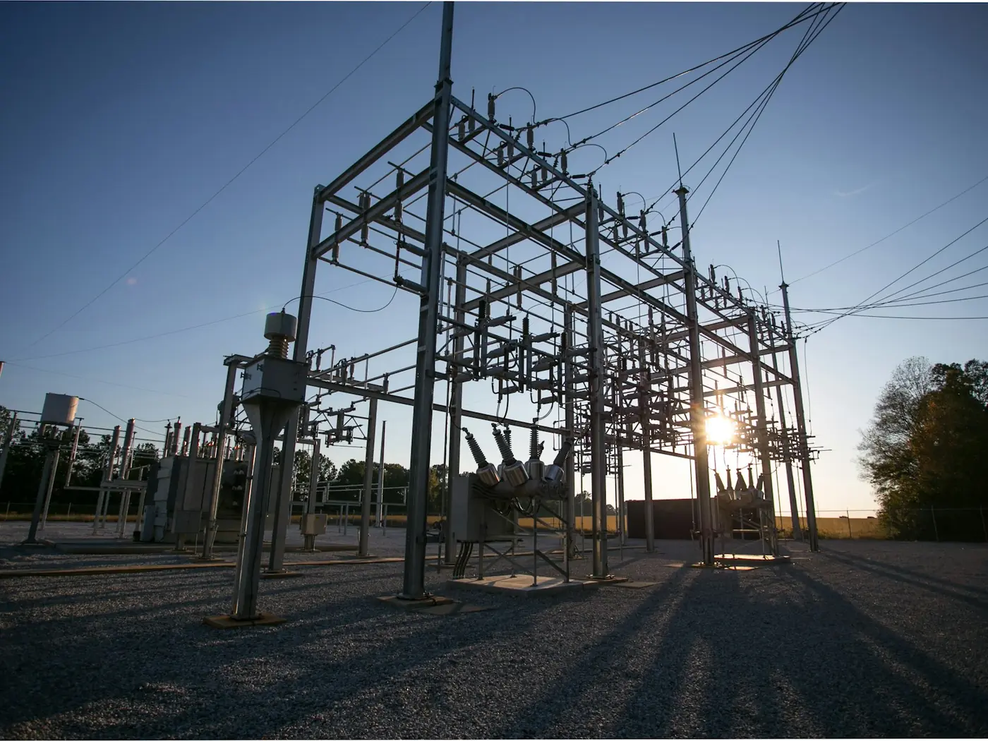 An electrical substation switchyard at low sun